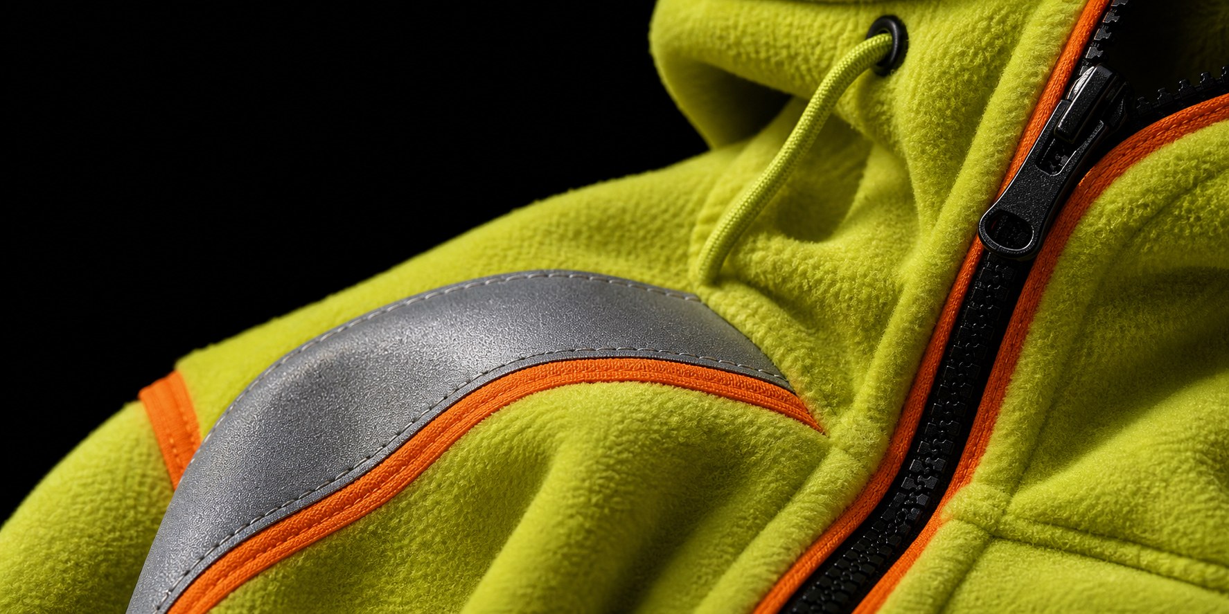 Close-up of a fluorescent fleece work layer with reflective detailing