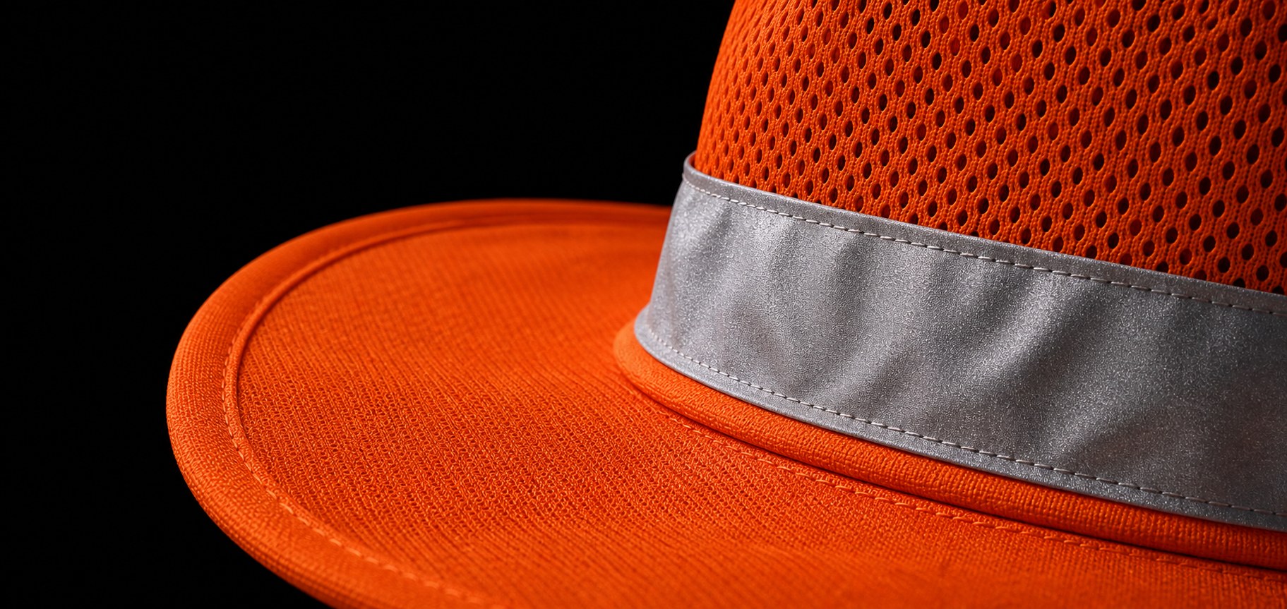 Close-up of a fluorescent orange safety hat with reflective material