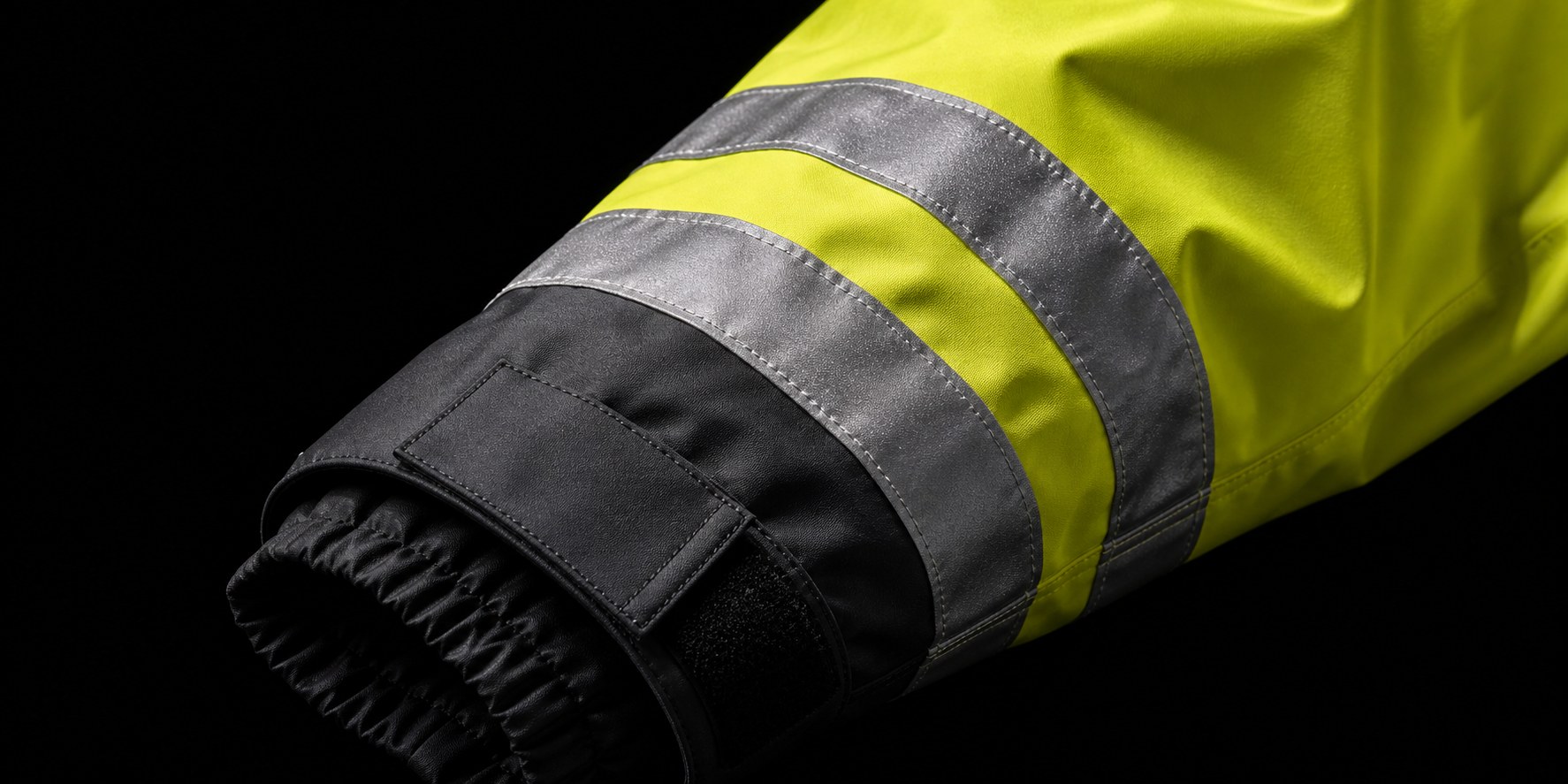 Close-up of fluorescent waterproof workwear with a reflective cuff