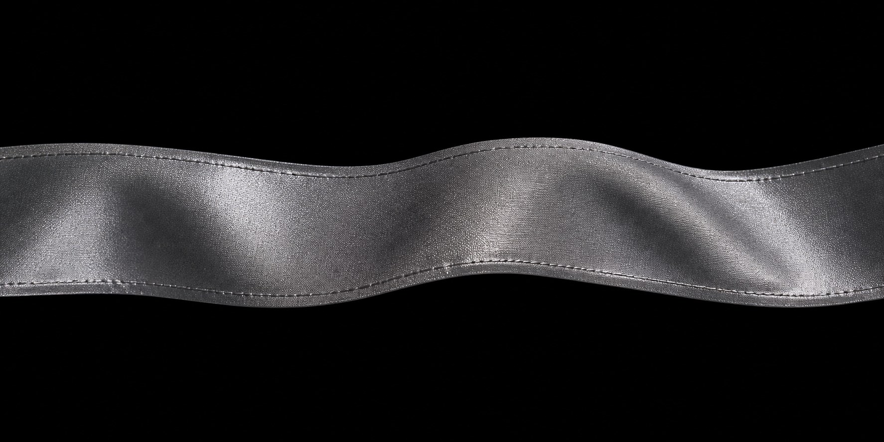 Macro photograph of silver retroreflective tape forming an S curve